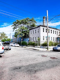 a street with cars parked in front of a building