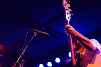 a man is playing a guitar at a concert